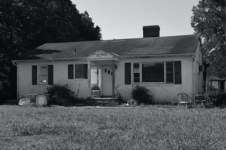 black and white photo of old abandoned house